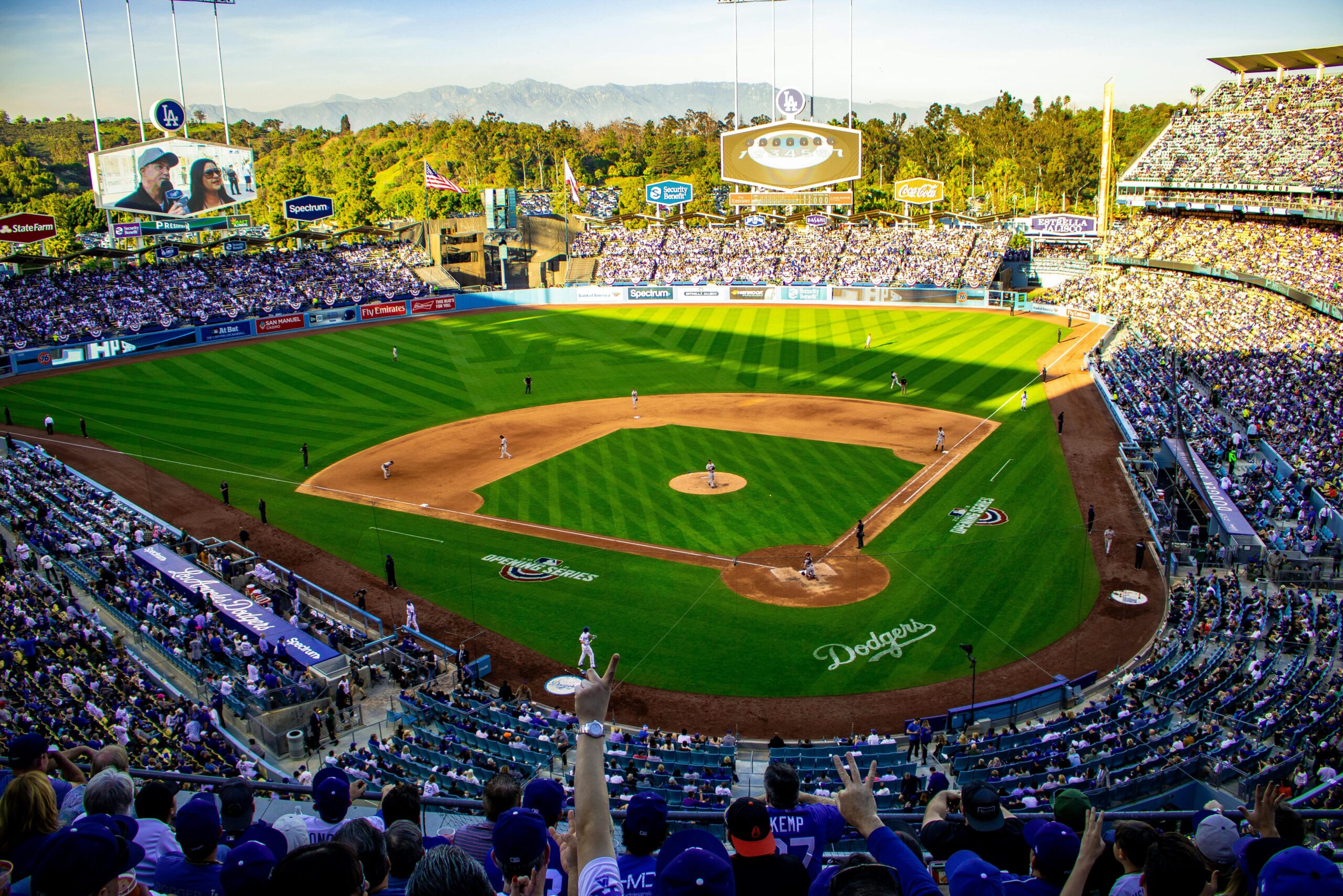 A lively baseball game at Los Angeles' iconic Dodger Stadium, capturing the vibrant atmosphere and full crowd.